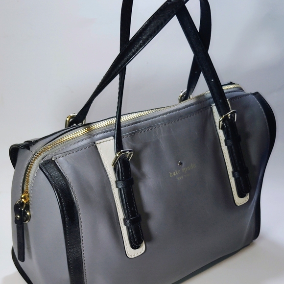 The Kate Spade Bedford Square leather handbag, sho strap is missing is a stylish